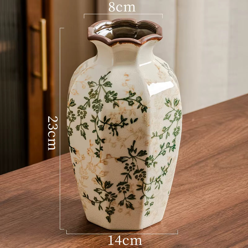 Ceramic vase with floral patterns on a wooden surface, showing measurements.