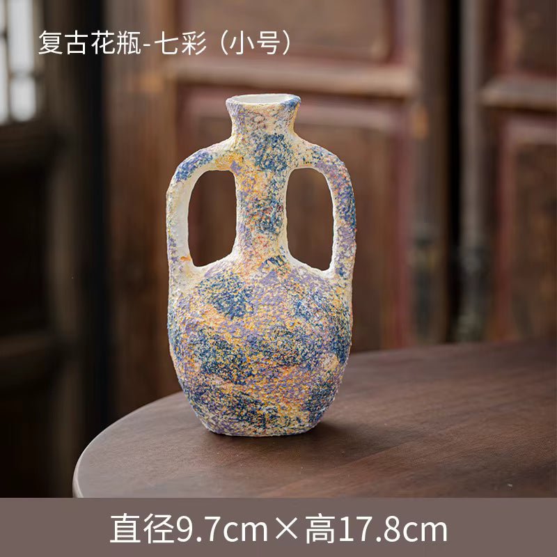 Decorative ceramic vase with speckled design on a wooden surface