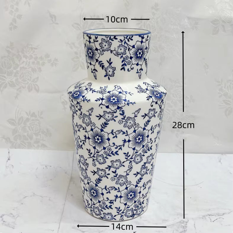 White vase with blue floral patterns and measurements on a white background