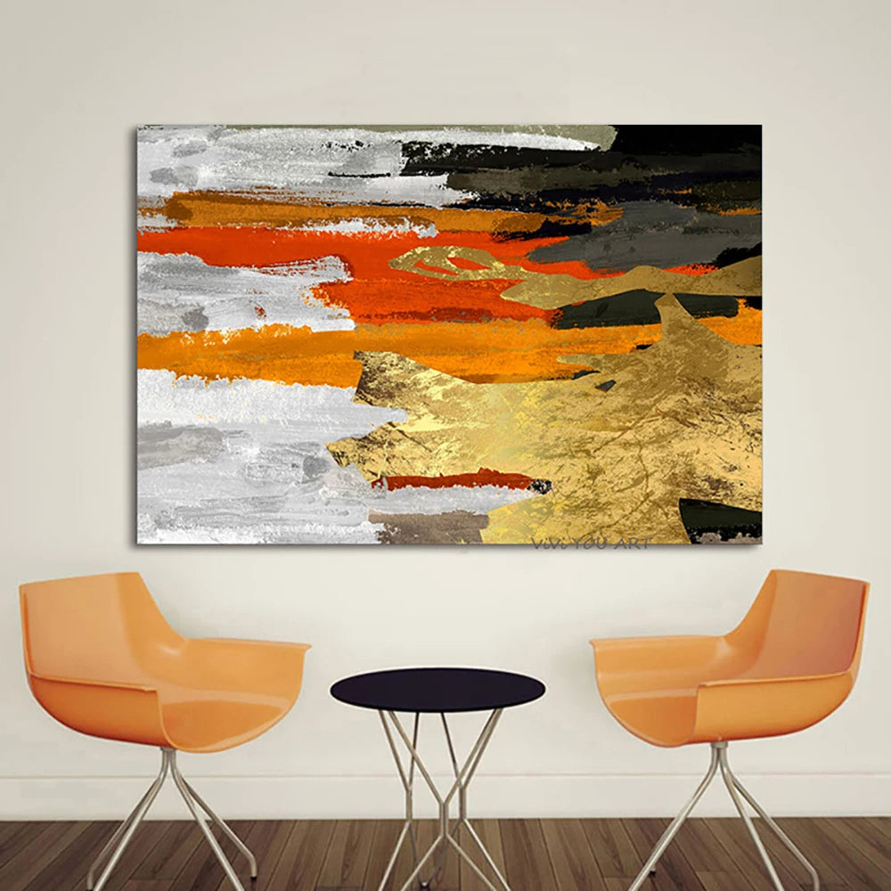 Abstract painting with orange, gold, and gray colors on a wall above two orange chairs and a small round table.