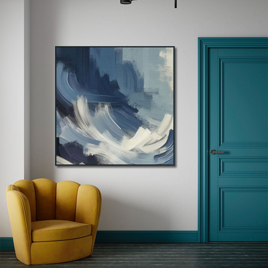Abstract painting on a wall above a yellow armchair with a teal door in the background