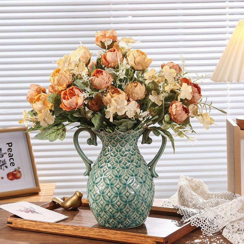 Decorative vase with flowers on a table in a room setting