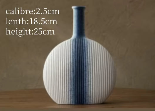 Blue and white striped vase on a wooden surface with measurements displayed.