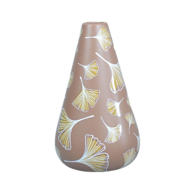 Decorative vase with leaf pattern on a white background