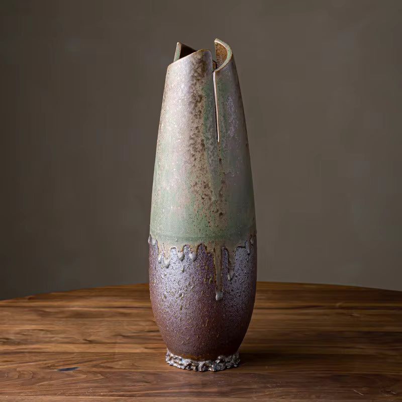 Ceramic vase with unique design on a wooden surface and dark background