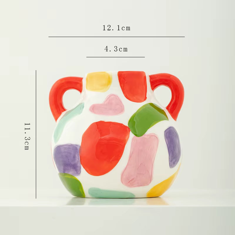 Colorful ceramic vase with measurements on a white background