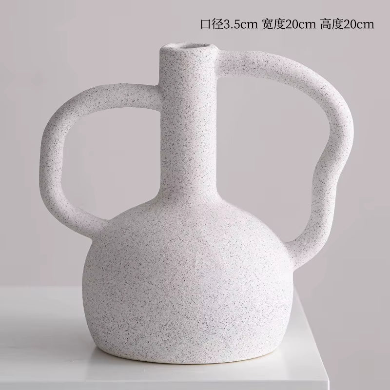 White textured vase with two handles on a light gray background