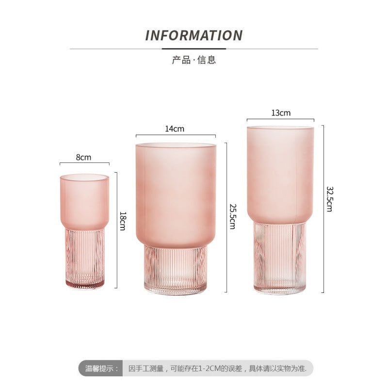 Set of three pink glass vases with measurements on a white background