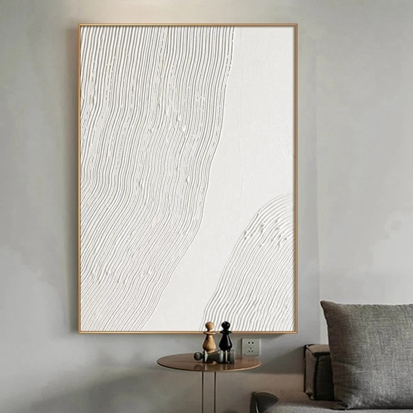 Abstract wall art with wavy lines in a gold frame on a gray wall.