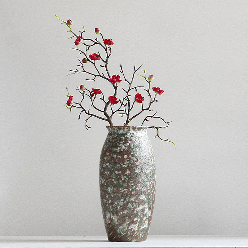 Decorative vase with floral branches on a plain background