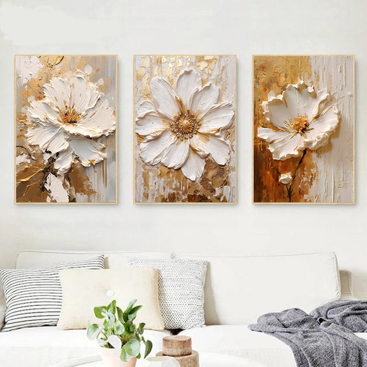 Three floral art pieces on a wall above a bed