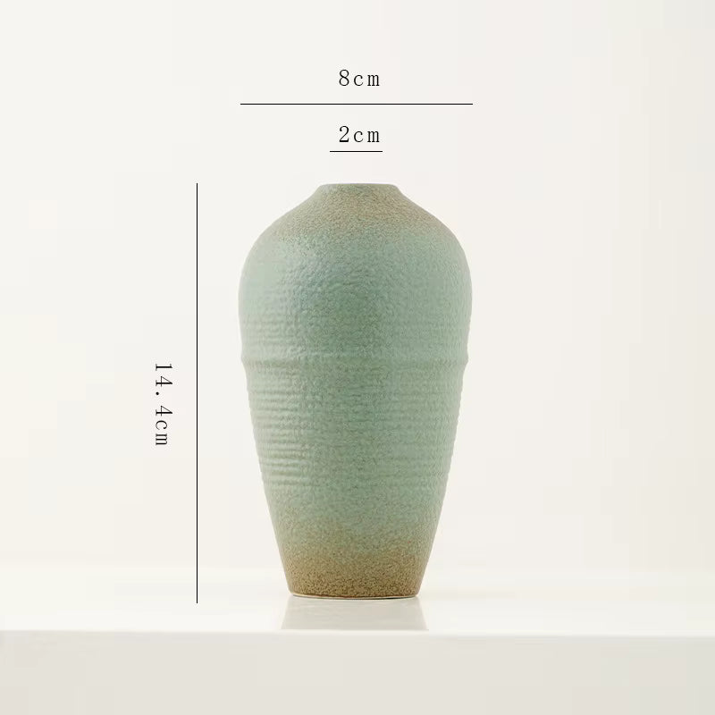 Green ceramic vase with dimensions on a white background