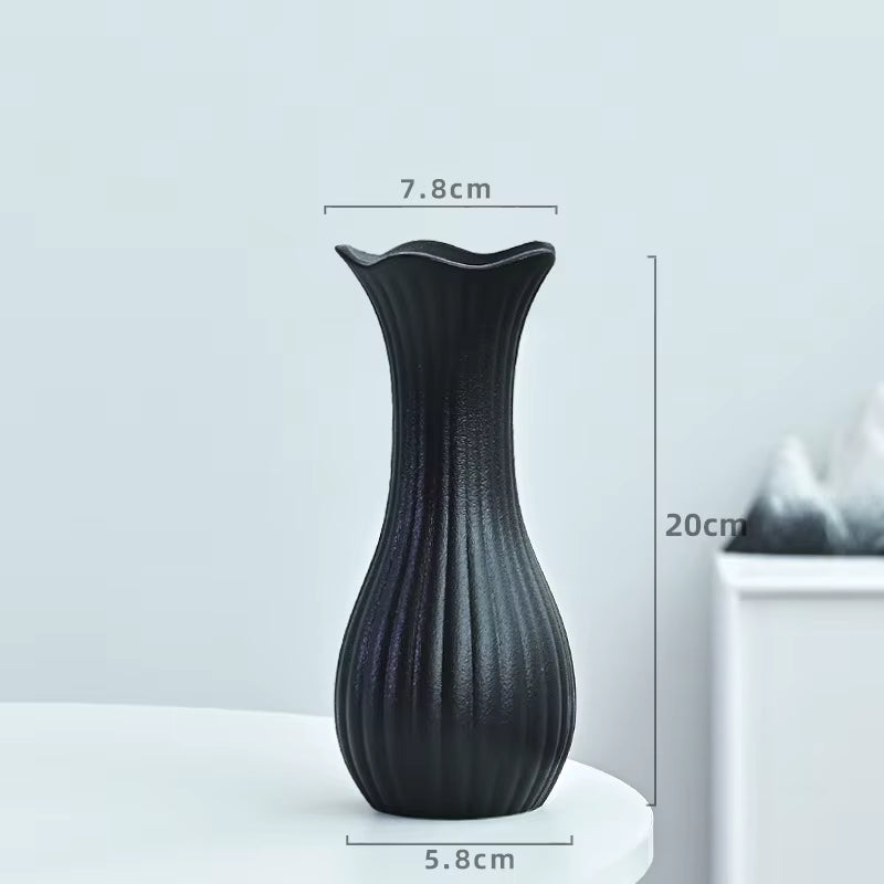 Black textured vase with dimensions on a light gray background