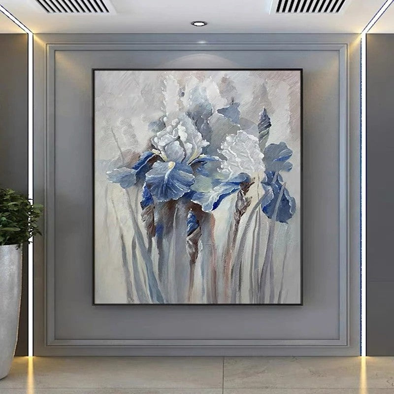 Framed abstract painting of blue flowers on a wall