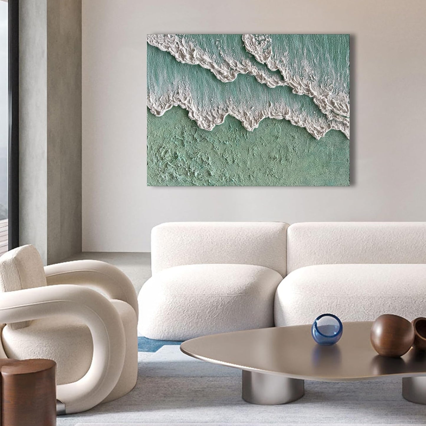 Modern living room with a white sofa, armchair, and coffee table, featuring a large abstract painting of waves on the wall.