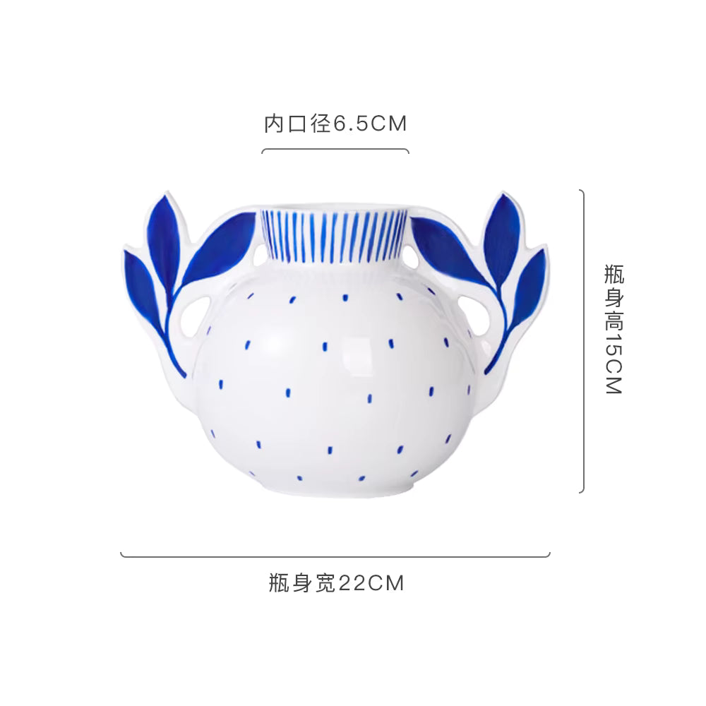 White ceramic jar with blue floral handles and patterns, shown with dimensions on a white background.