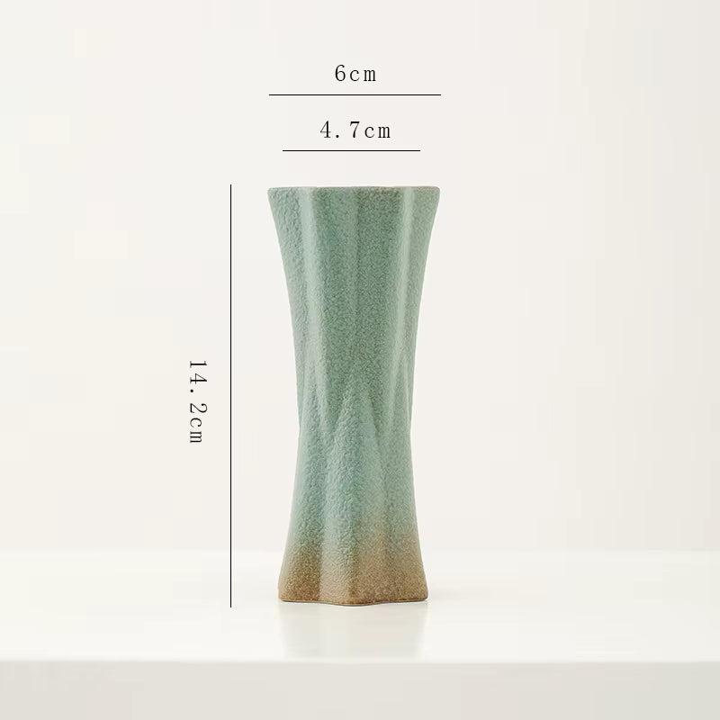 Green ceramic vase with dimensions on a white background