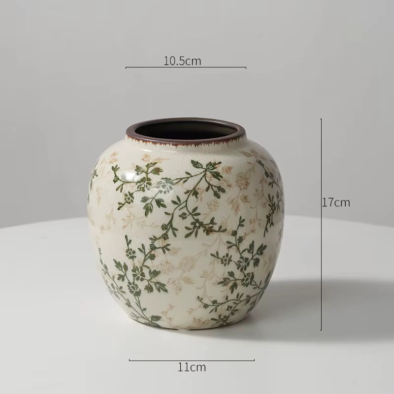 Ceramic vase with floral patterns and dimensions on a gray background