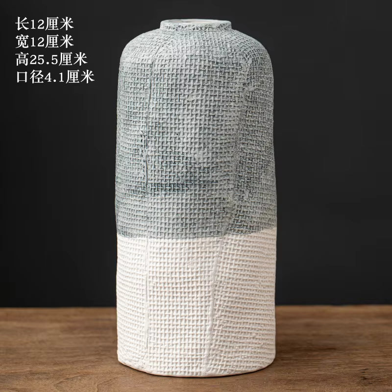 Decorative vase with textured design on a wooden surface and black background