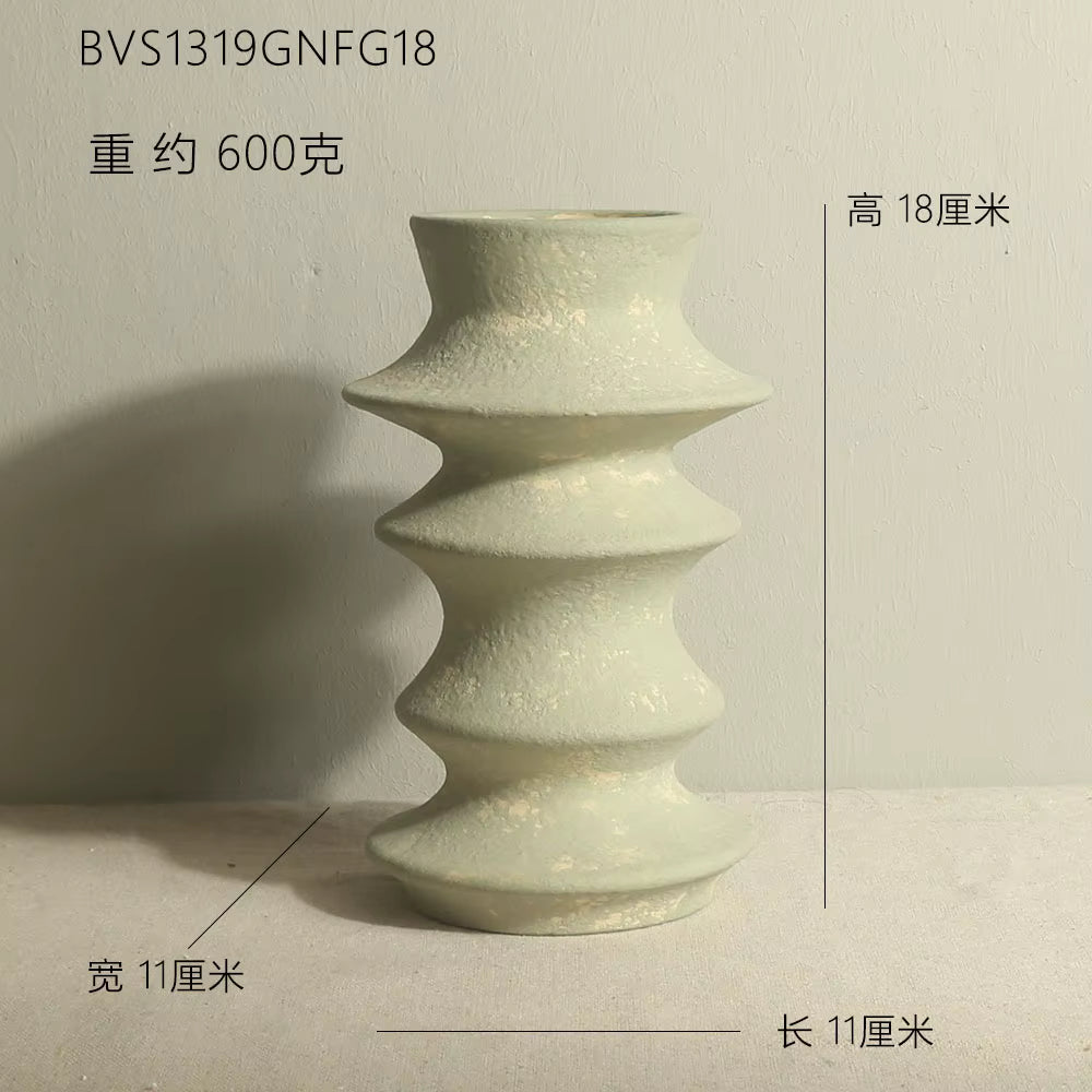 Green ceramic vase with measurements on a light gray background