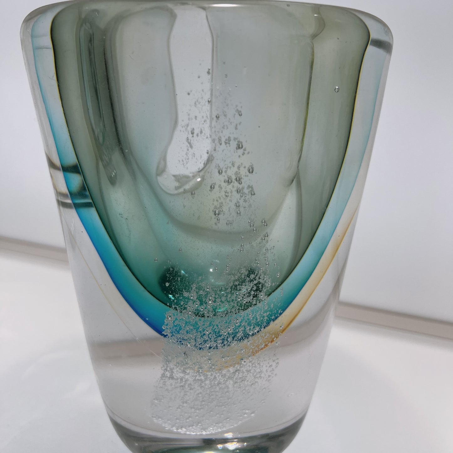 Glass vase with a textured design on a white background
