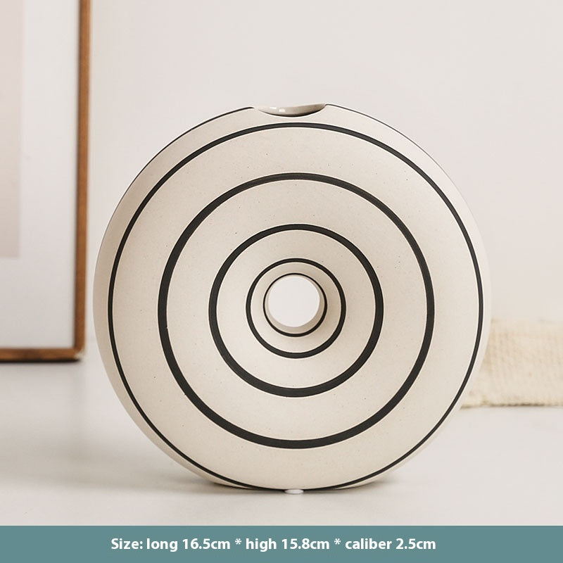 Round decorative item with concentric circles on a light background