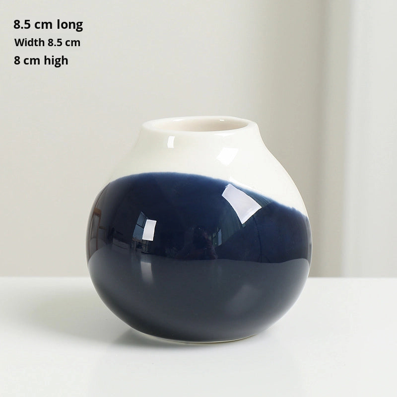 Navy blue and white vase on a light background with dimensions displayed.