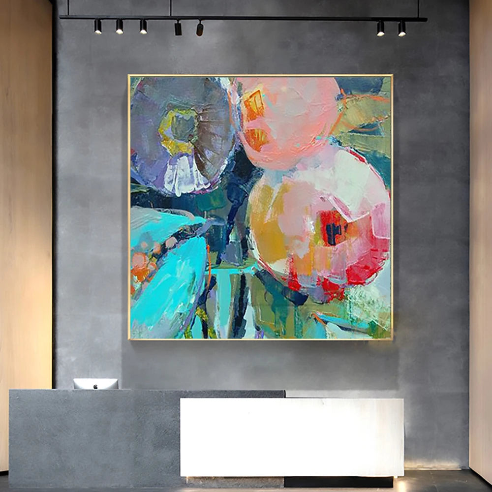 Abstract painting on a gray wall above a modern reception desk.