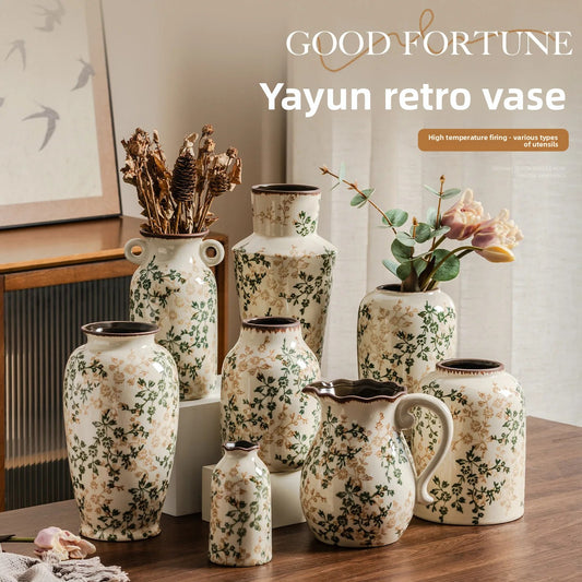 Set of decorative vases with floral patterns on a wooden surface, featuring the brand 'Yayun'.