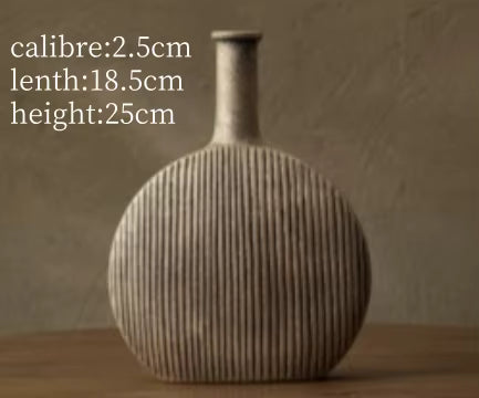 Textured vase on a wooden surface with measurements displayed