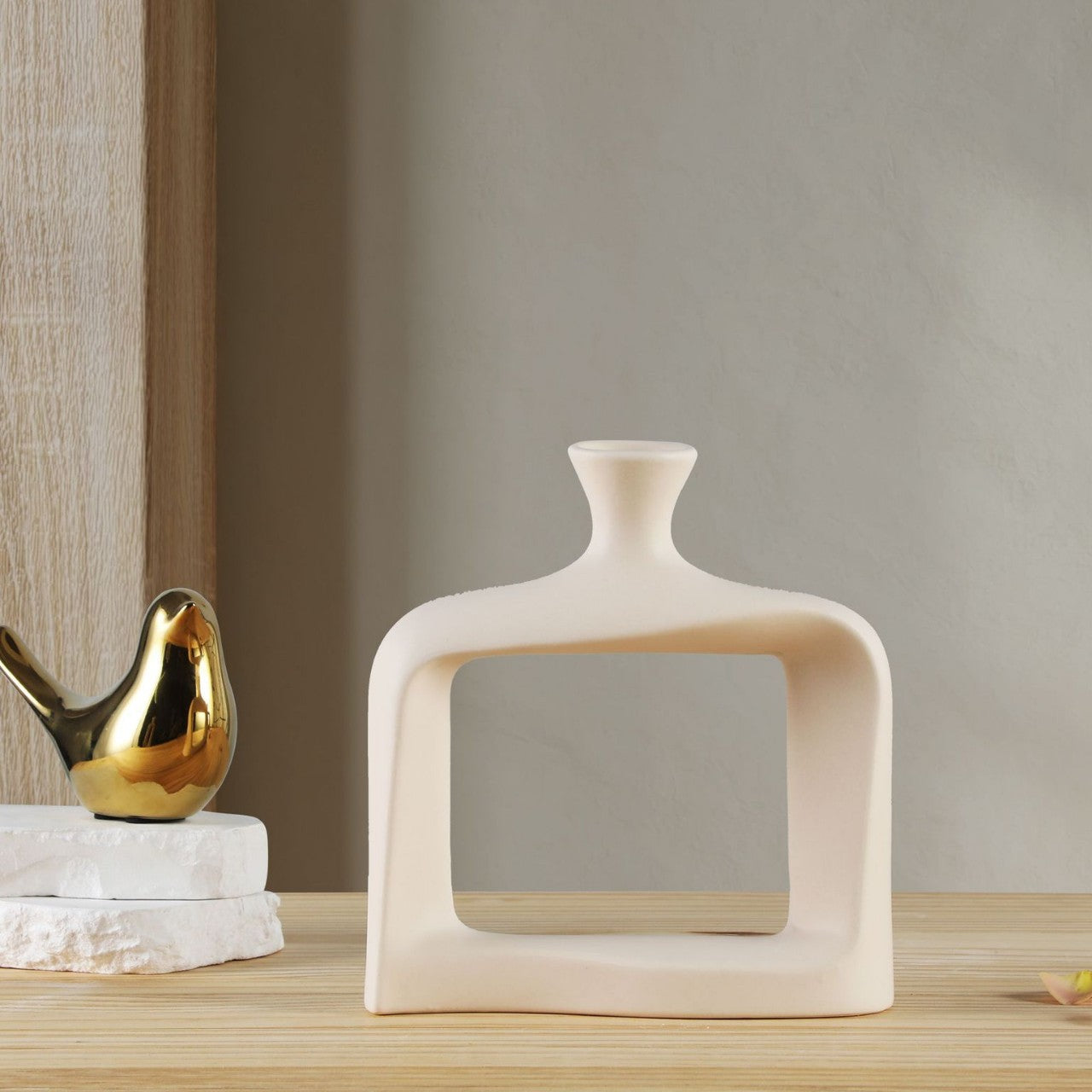 Decorative vase on a wooden surface with a neutral background