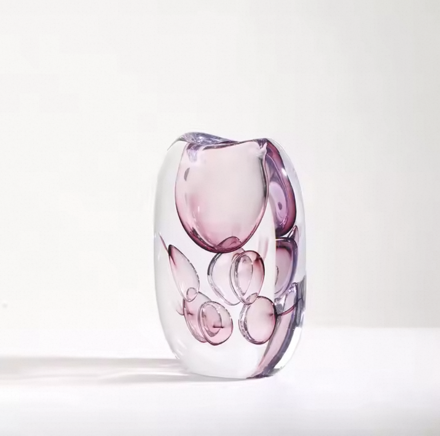 Glass vase with pink and clear design on a white background