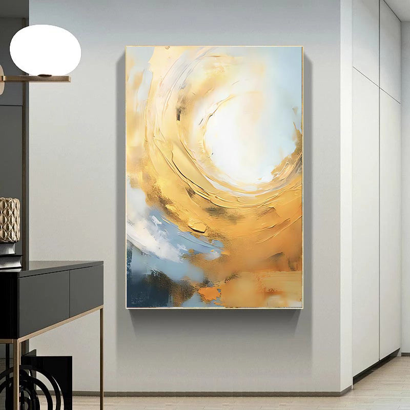 Abstract painting with gold and blue tones on a wall in a modern interior setting.