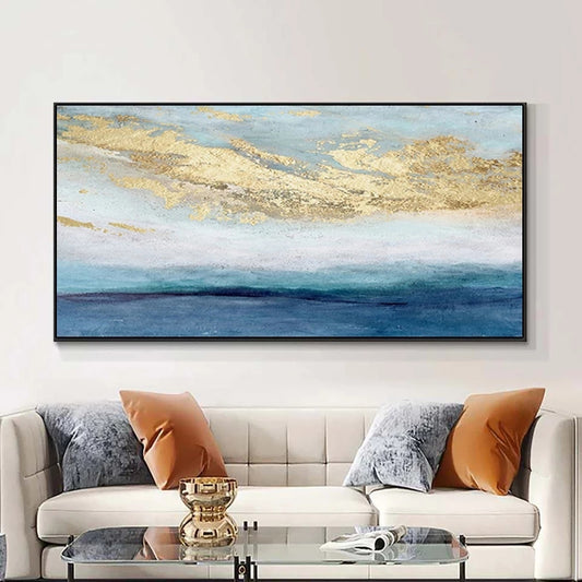 Framed abstract artwork above a sofa with decorative pillows in a living room setting.