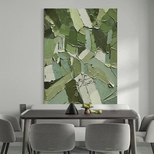 Dining room with a large abstract green painting on the wall above a table.