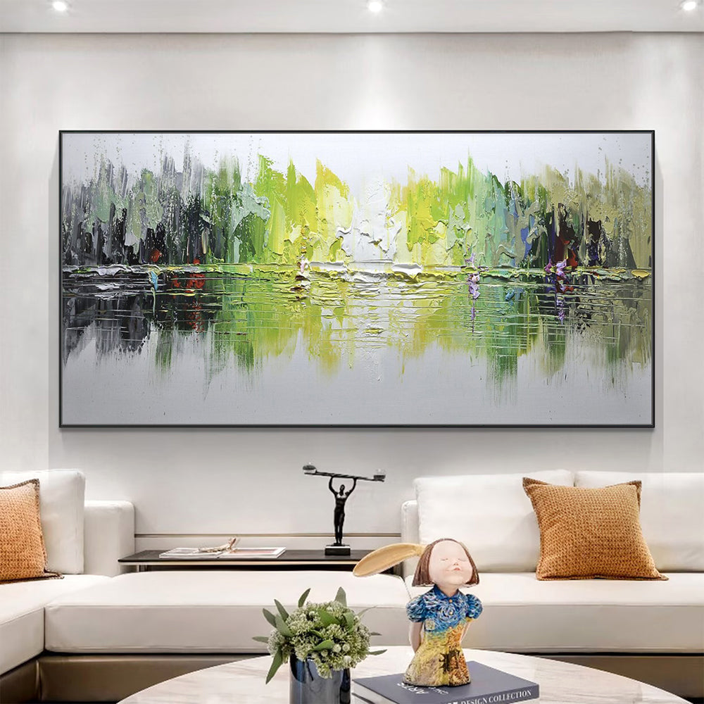 Living room with a large abstract painting on the wall, white sofa, and decorative items.