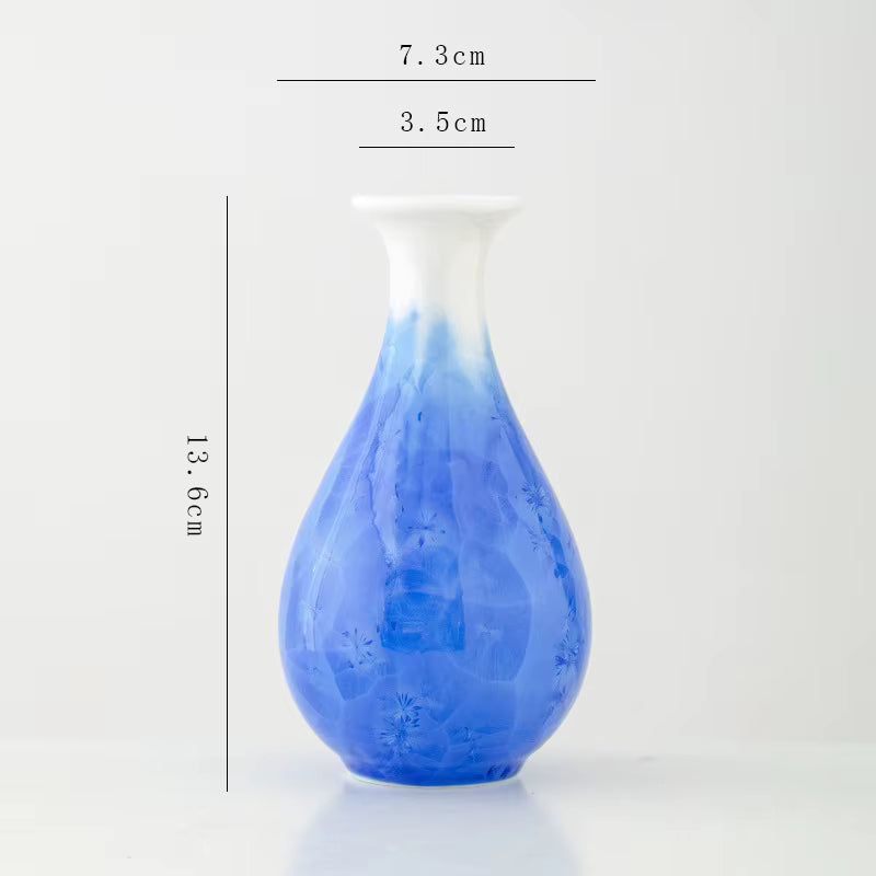 Blue glass vase with measurements on a white background