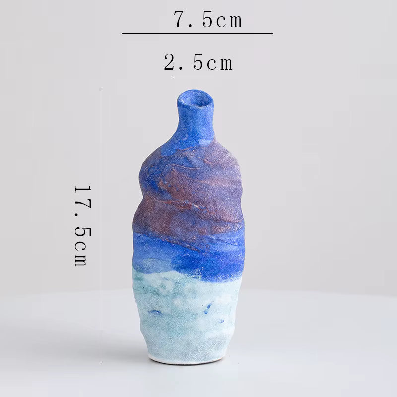 Blue and brown ceramic bottle with measurements on a white background