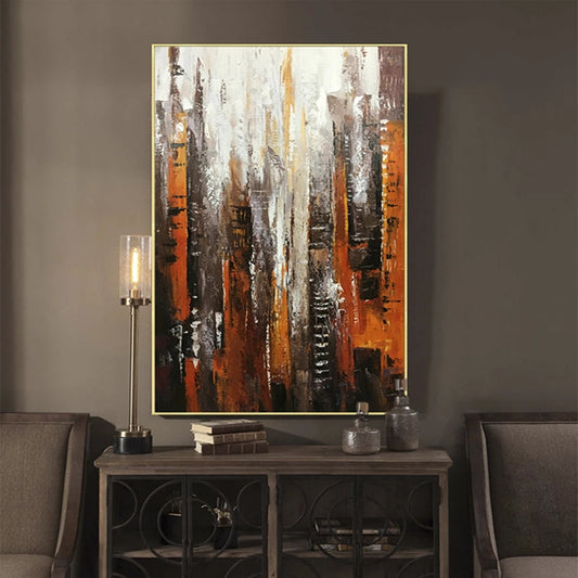 Abstract painting in a living room setting with a console table and chairs.