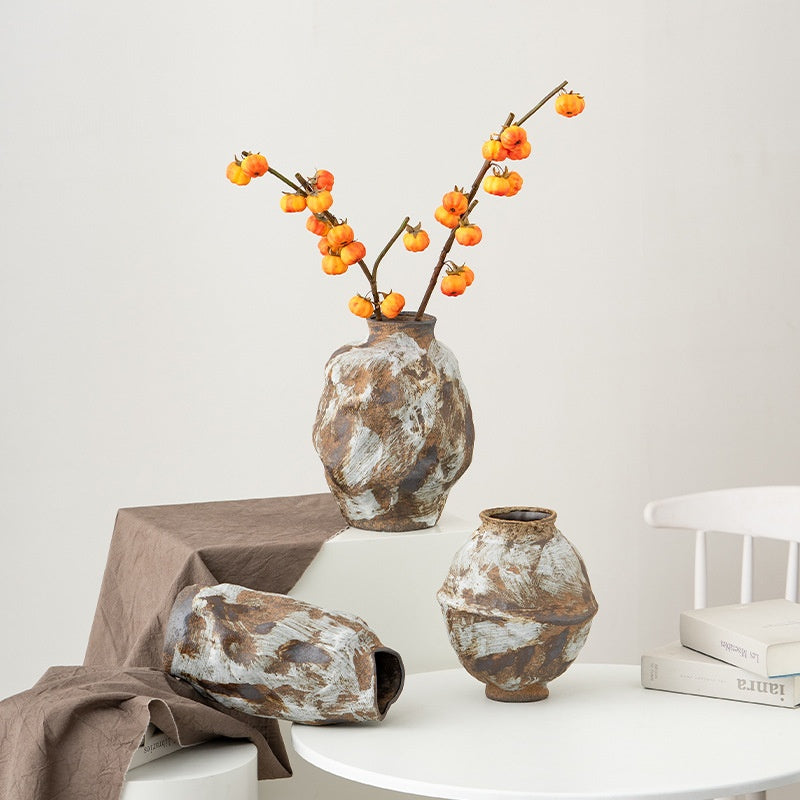 Decorative vases with floral arrangement on a white surface