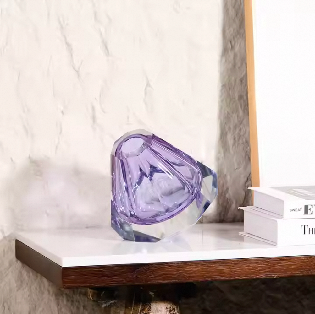 Decorative purple crystal on a shelf against a marble wall