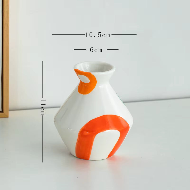 White vase with orange accents and measurements on a white background