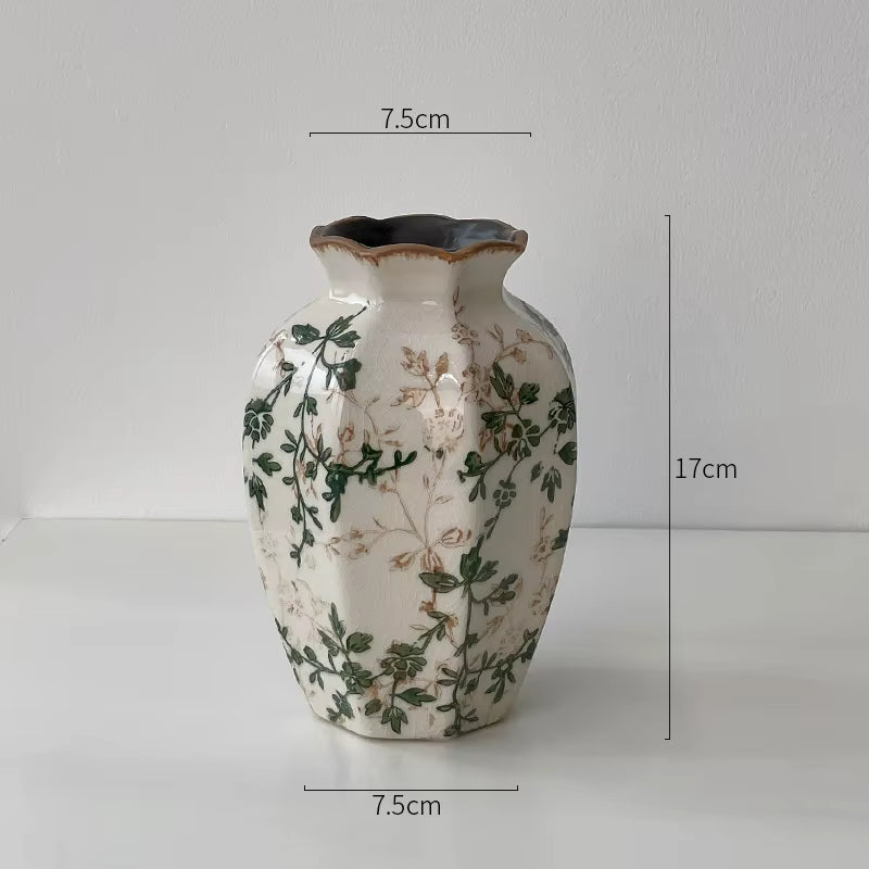 Decorative vase with floral patterns and measurements on a plain background
