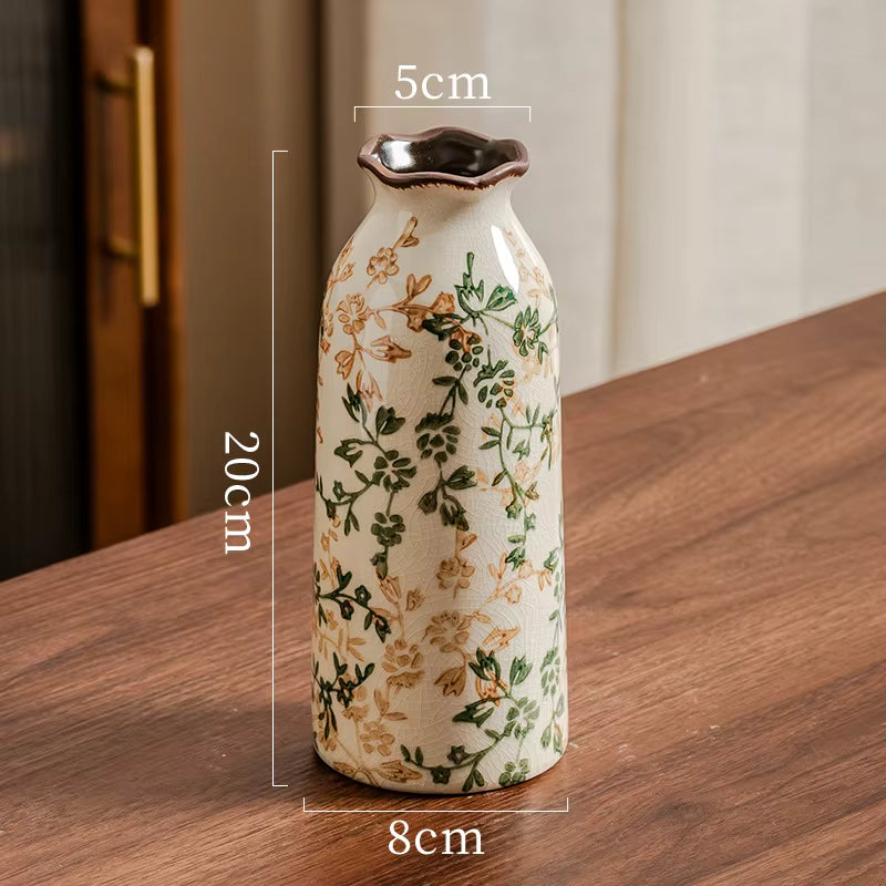 Decorative ceramic vase with floral patterns on a wooden surface, showing dimensions.