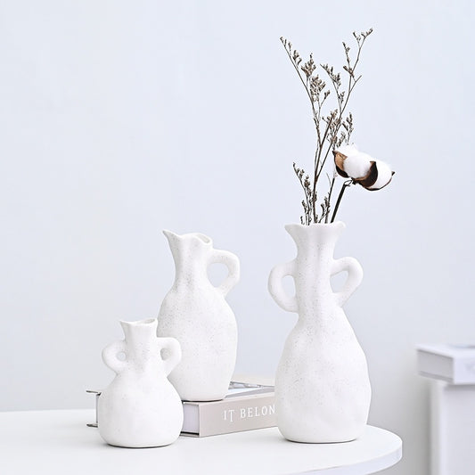 Set of white ceramic vases on a light gray background