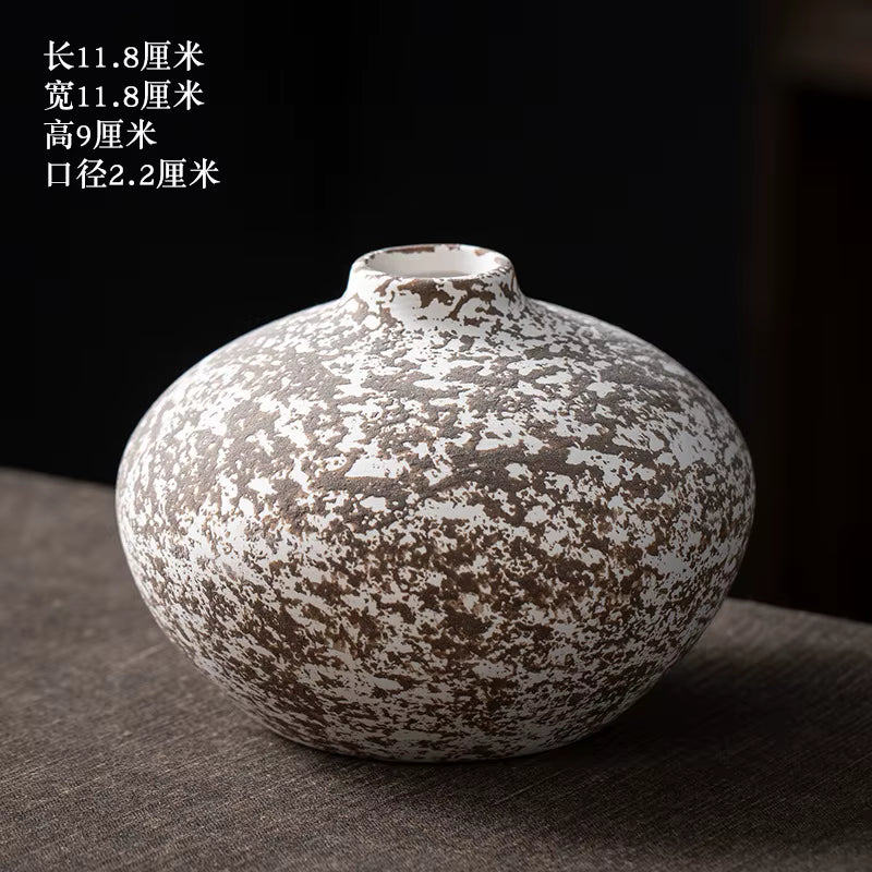 Vintage-style ceramic vase with textured surface on a dark background