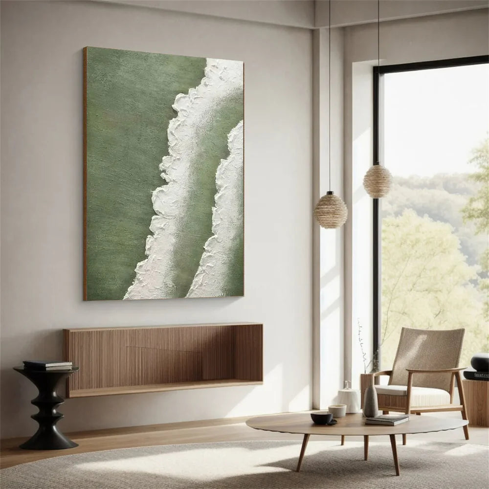 Modern living room with abstract art on the wall and a view of trees outside.