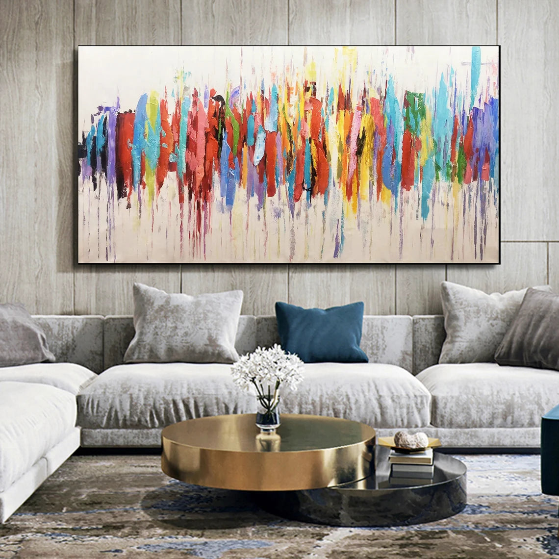 Living room with a colorful abstract painting on the wall above a gray sofa.