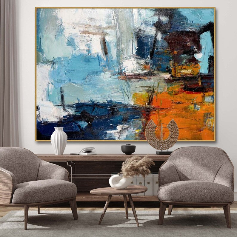 Living room with abstract painting, chairs, and decorative items.