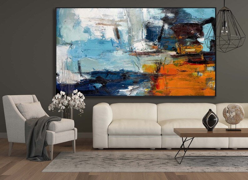 Living room with a large abstract painting on the wall, white sofa, and decorative items.